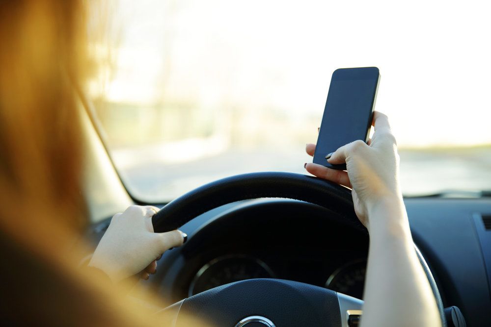 Woman driving and texting