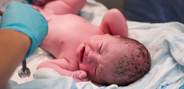 An infant in the delivery room